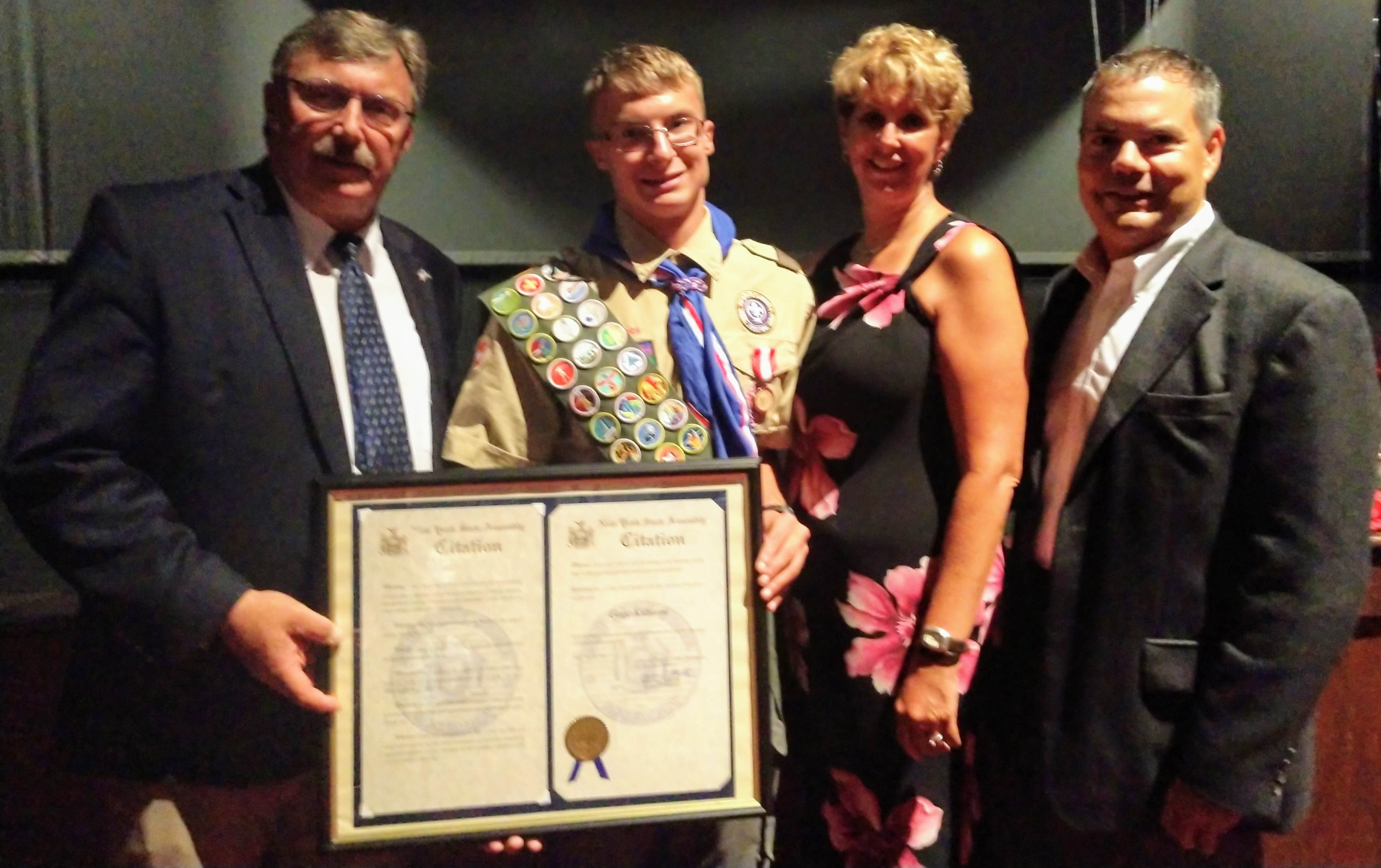 Pictured above: Assemblyman Brian Miller (far left) presents a citation to Eagle Scout Gage Kilborne on July 30, 2019 in New Hartford. Also pictured are his parents, Tammy and Carl Kilborne.