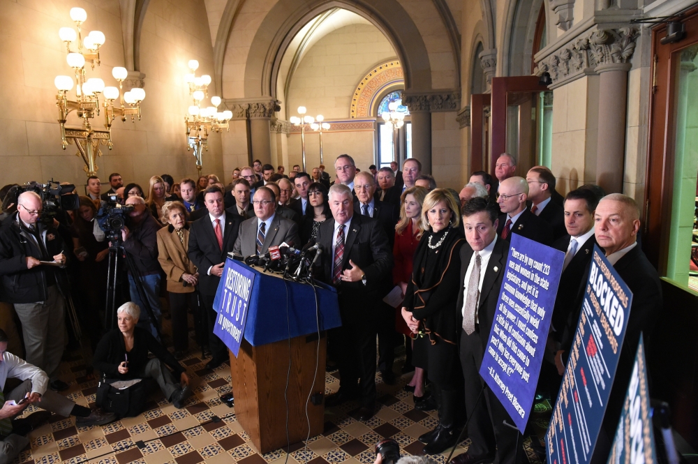 Assemblyman Christopher S. Friend (R,C,I-Big Flats) looks on as Assembly Minority Leader Brian M. Kolb addresses the media at the Restoring Trust in Government press conference stressing the necessity