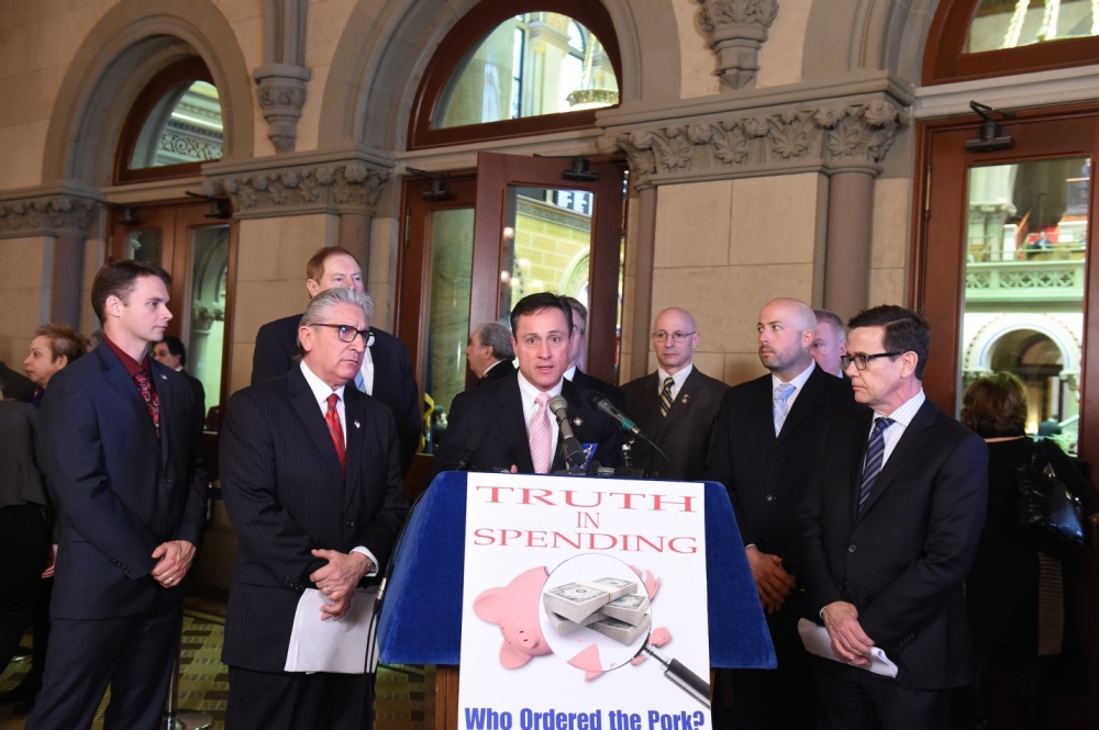 Assemblyman Christopher S. Friend (R,C,I-Big Flats) looks on as Assemblyman Peter Lopez addresses the media at the “Truth in Spending” press conference.