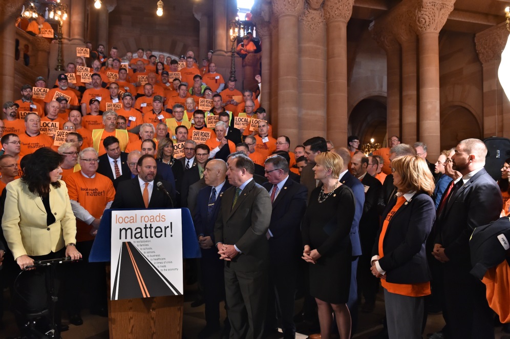 Assemblyman Christopher S. Friend (R,C,I-Big Flats) rallies with highway superintendents in the state Capitol calling for a $150 million increase to local aid for local roadways and the restoration of