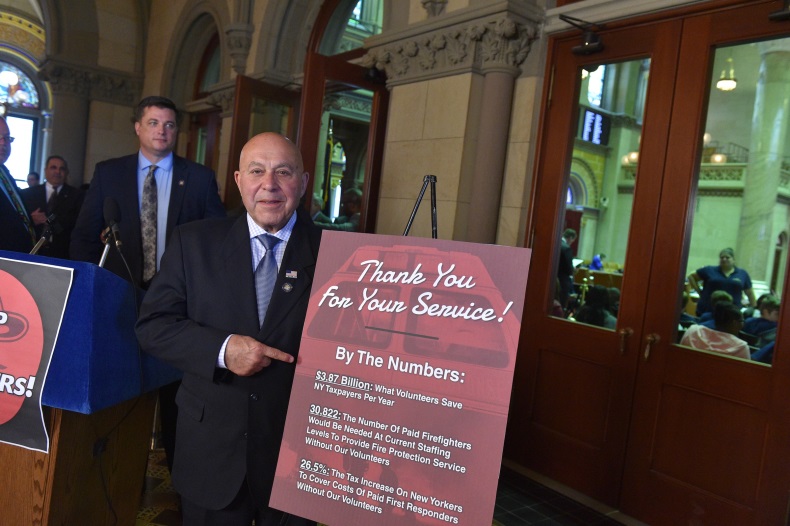 Assemblyman Angelo J. Morinello (R,C,I-Ref-Niagara Falls) joins members of the Legislature and local firefighters at a press conference on Monday, May 20.